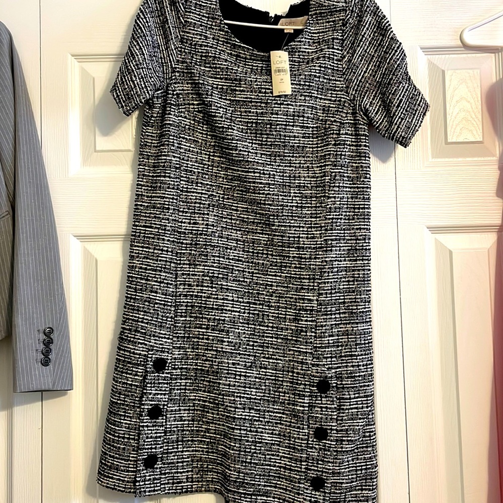 Black and white dress with cute button detailing at the bottom